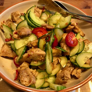 Asian spicy chicken with cucumber - mixing the whole.